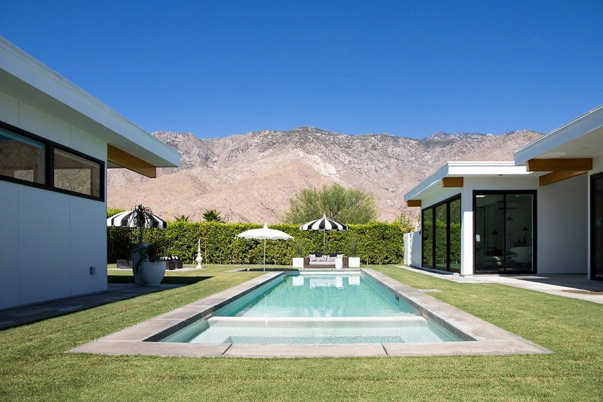 Pool courtyard of the 180 House Lindal home, framed by its post-and-beam wings and the San Jacinto mountains